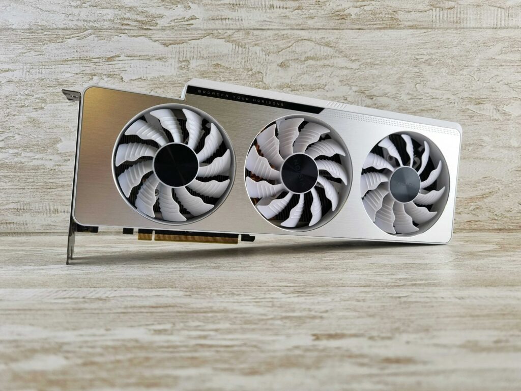 A gaming laptop on a cooling pad with adjustable fans for enhanced cooling performance.